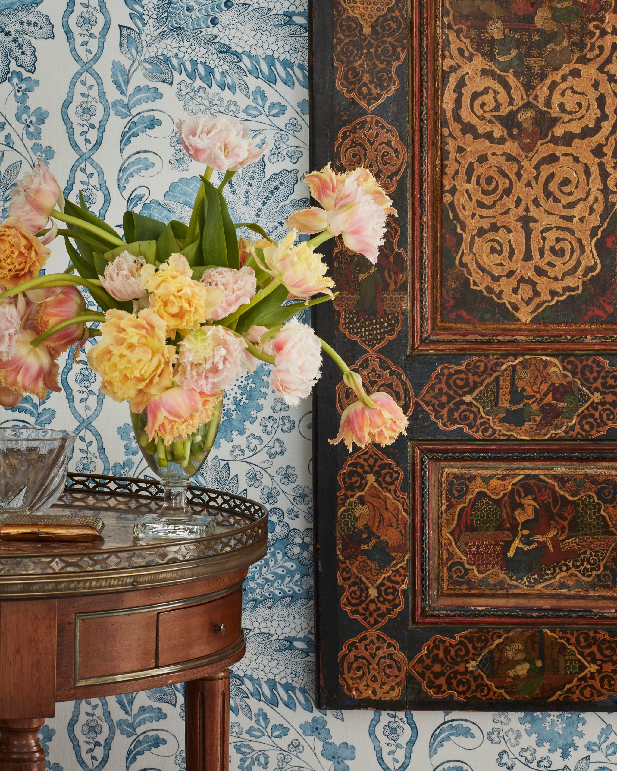 Marshall Watson New York Apartment Bedroom Wall floral arrangement on an antique table with an antique door hung on the wall