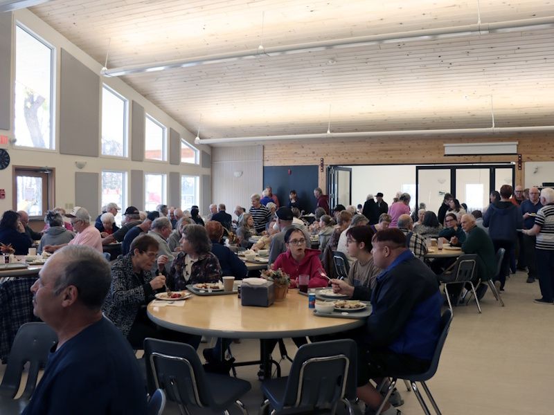 a group of people sitting around tables eating a meal