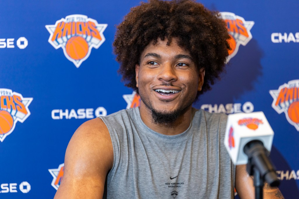 New York Knicks guard Miles McBride speaks with members of the media at a press conference.