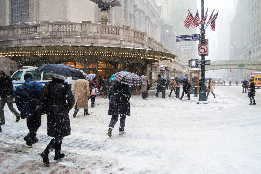 Commuters deal with the snow near Grand Central Terminal during Winter Storm Janus on January 21, 2014 in Manhattan