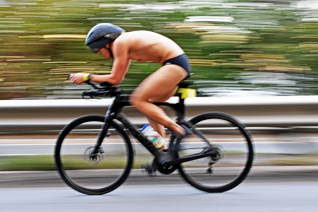A competitor in the NYC Triathlon races on a bicycle.