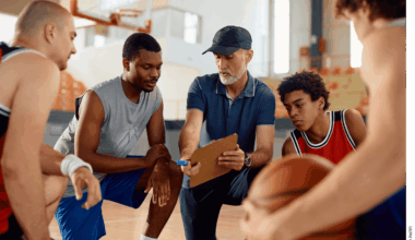 A coach discusses a play with a basketball team