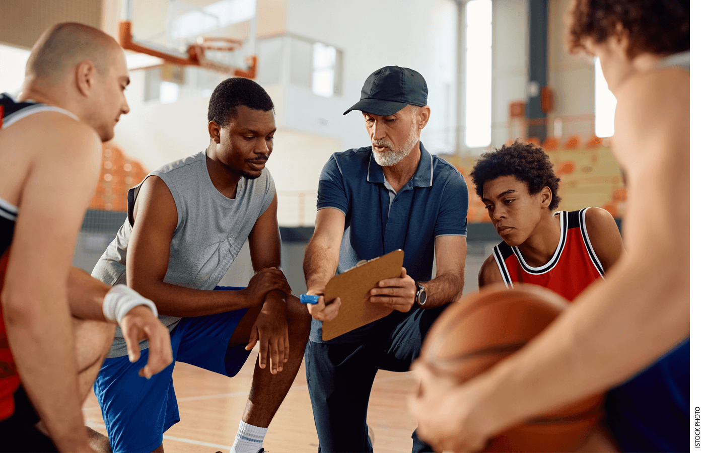 A coach discusses a play with a basketball team