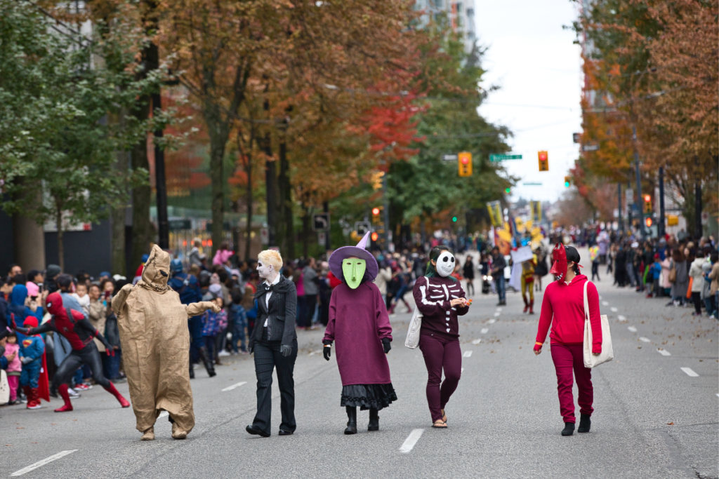 people walking down the street dressed in halloween costumes
