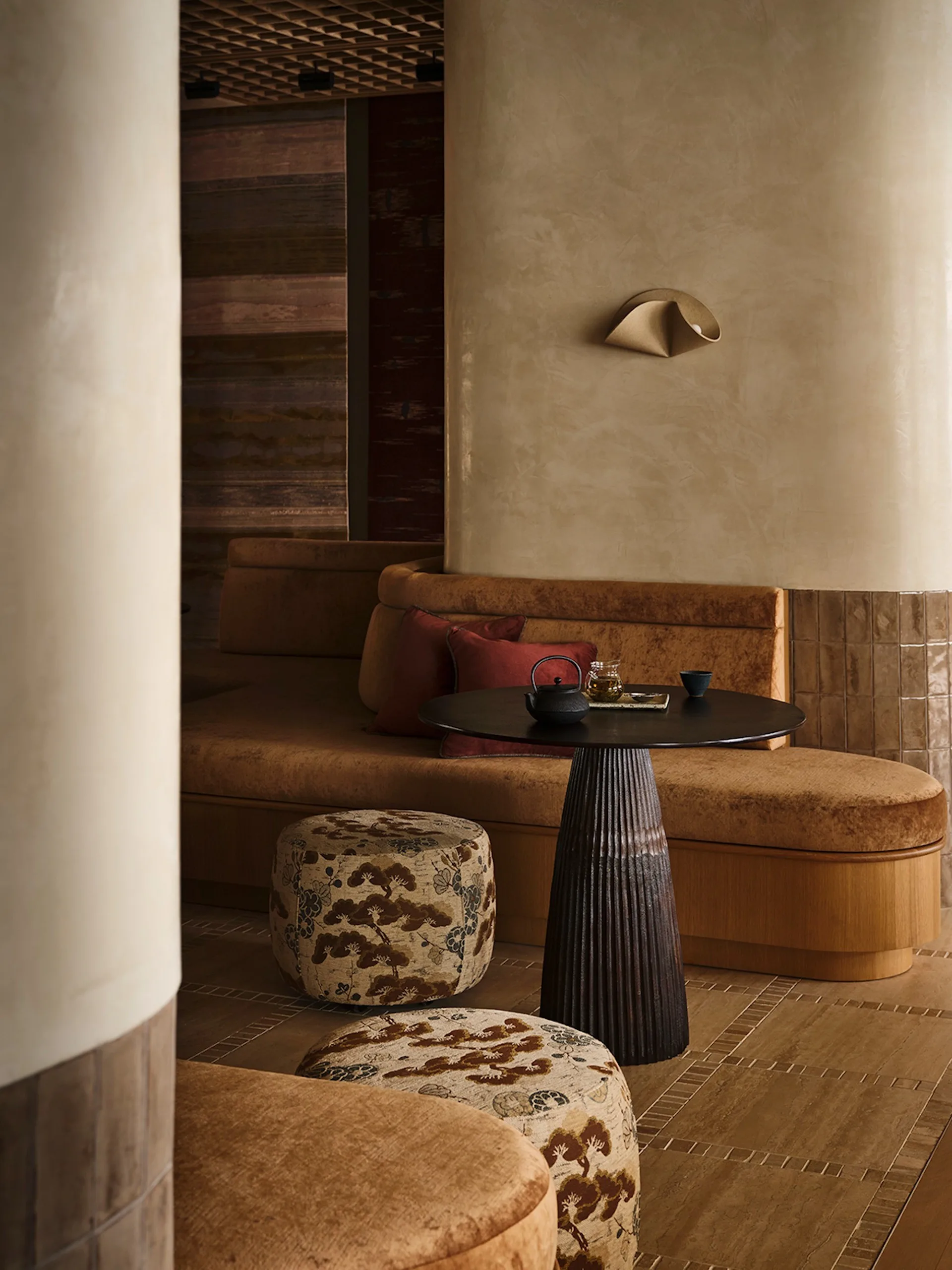 Showroom with ambient lighting highlighting decor and rugs.
