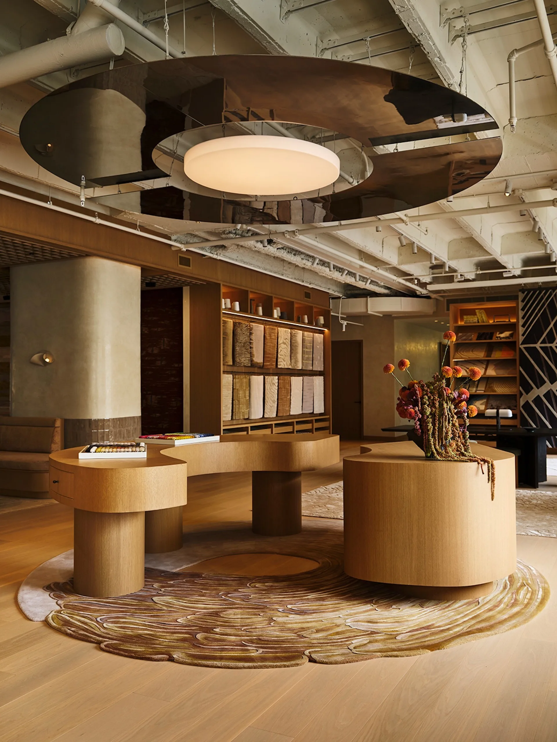 Designer furniture set against a backdrop of decorative panels.