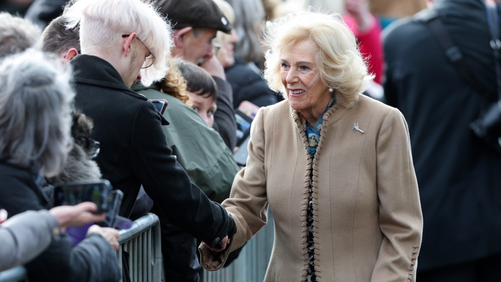 Queen Camilla wears the Welsh Guards Diamond Leek Brooch as she greets members of the public during their visit to Aberfan Memorial Garden to mark the 60th anniversary of the Aberfan disaster on Oct. 21, 2026 in Merthyr Tydfil, Wales.