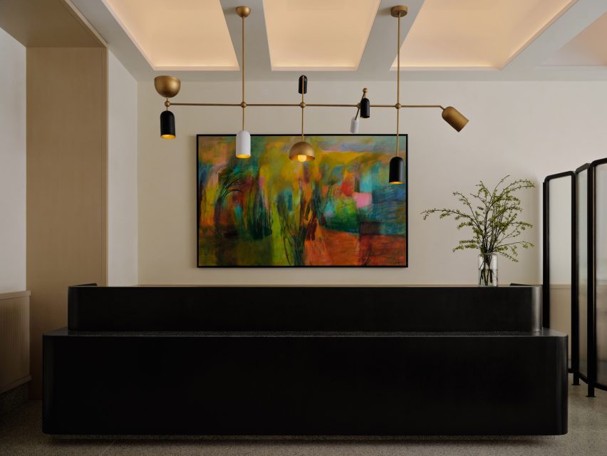 A reception area anchored by a tiered black-stone counter