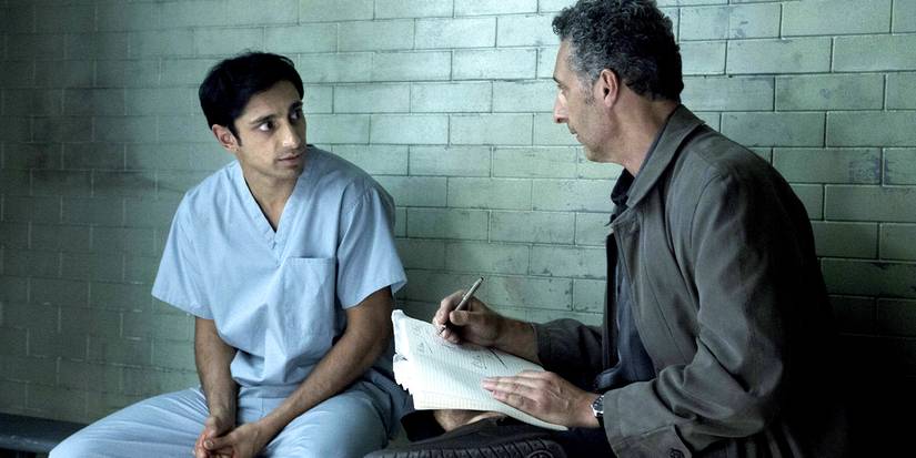 John Turturro speaking with Riz Ahmed in a jail cell in 'The Night Of'.