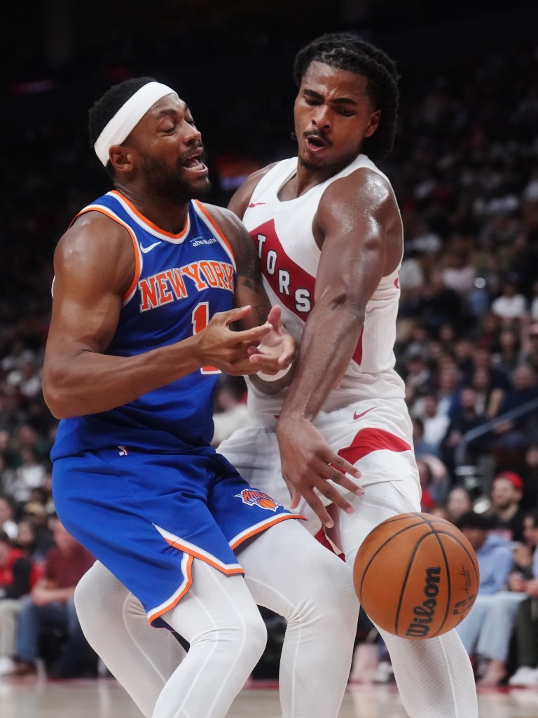 New York Knicks guard Bruce Brown and Toronto Raptors forward Collin Murray-Boyles battle for the ball during a game.