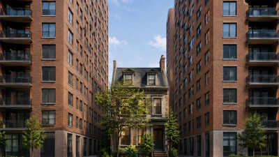 In 1916, a New York widow raising five children refused to sell her Manhattan row house; developers put 14- and 15-storey apartment buildings on both sides, leaving her home standing