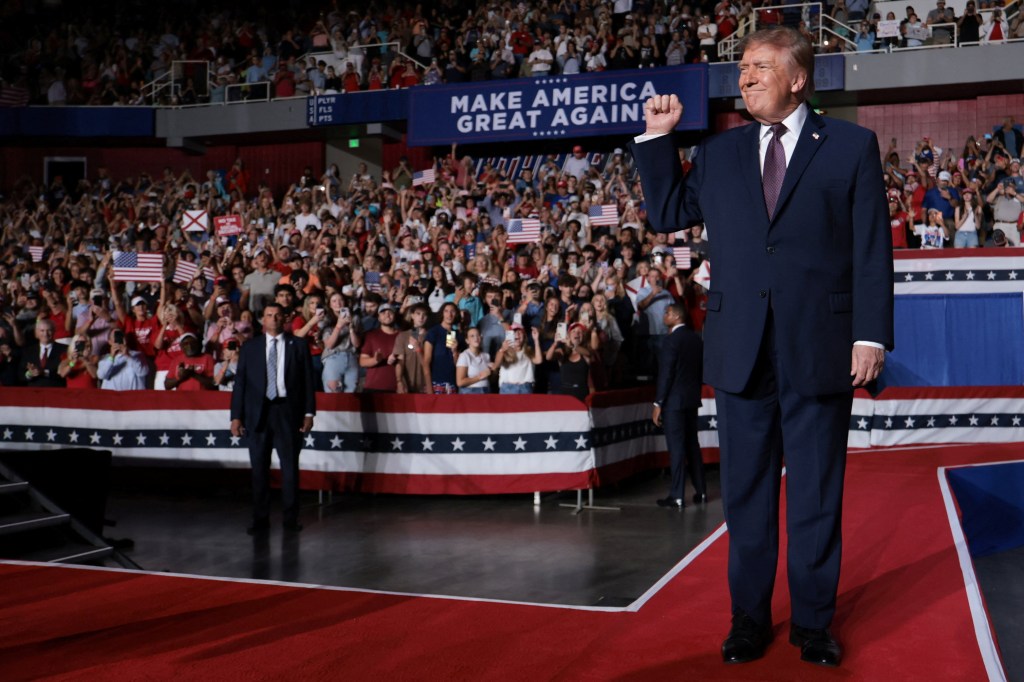 U.S. President Donald Trump raises his fist at a rally ahead of the midterm elections at the University of South Alabama in Mobile, Alabama.