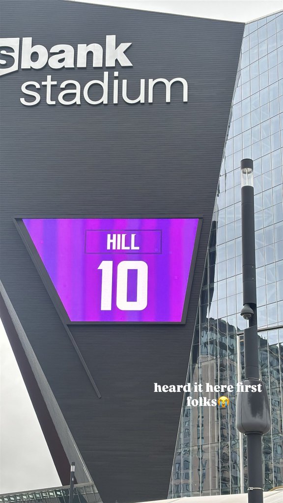U.S. Bank Stadium's exterior digital board displaying the name "HILL" and number "10" in Vikings purple and white.