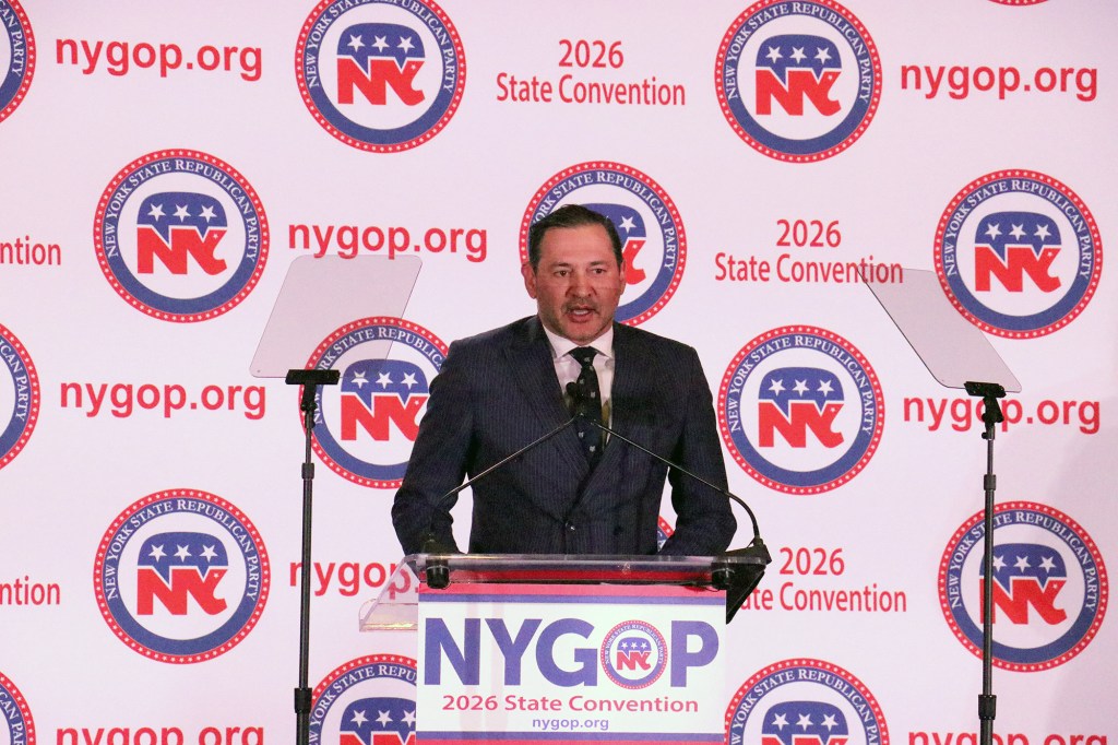 Wall Street investor Joseph Hernandez speaks at a podium at the NYS GOP Convention.
