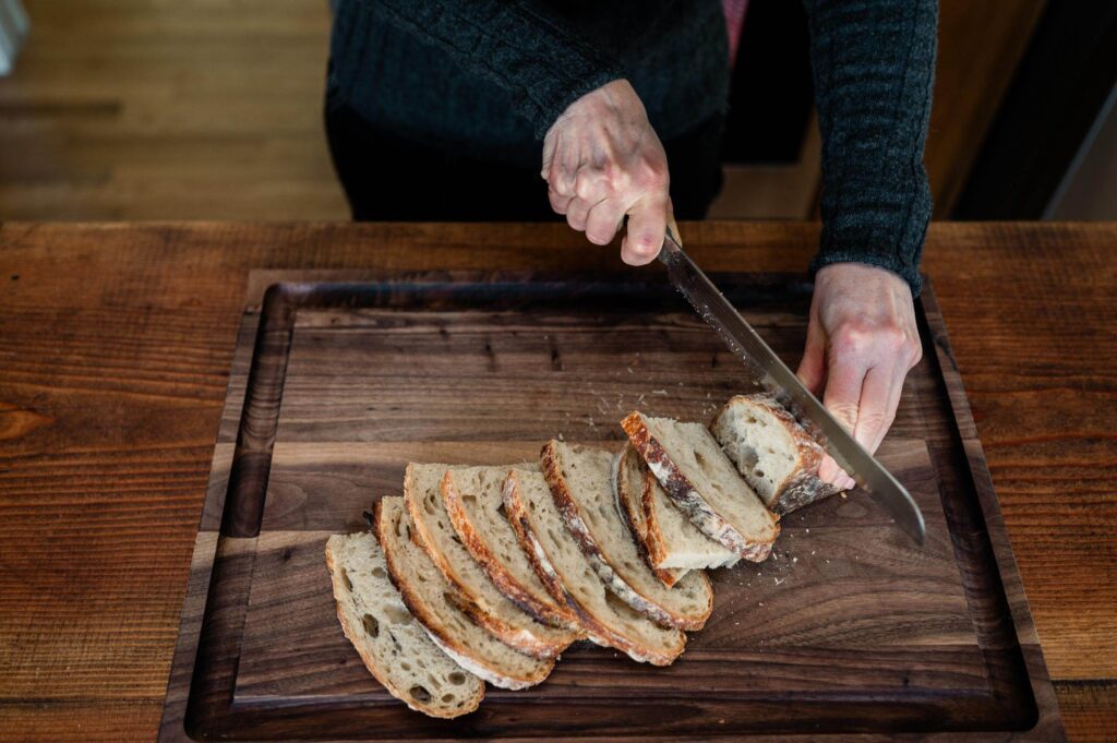 Anne-Marie Bonneau slicing sourdough bread