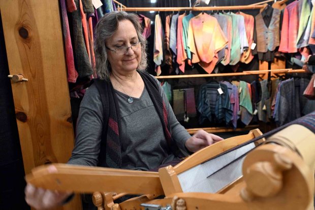 Kathy Dinsmore of Punxsutawney, formerly of Robesonia, weaves a scarf during the 75th annual Reading-Berks Guild of Craftsmen Juried Holiday Fine Art and Craft Festival at Kutztown University on Saturday, Oct. 25, 2025. (BILL UHRICH/READING EAGLE)