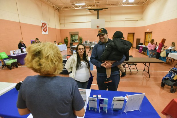 Immanuel Cabreiroa, of Scranton, holding his son Manny, 2, and...
