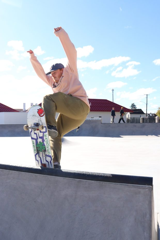 Bazaar Skateshop co-owner Caleb Hartnett rides over the top of...