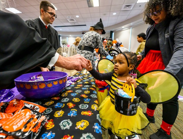 Juju, of Love You More Early Learning Center receives treats on Friday, Oct. 31, 2025, during a Trick-or-Treat Candy Land themed adventure hosted by Lehigh County at Government Center in Allentown. (April Gamiz/The Morning Call)