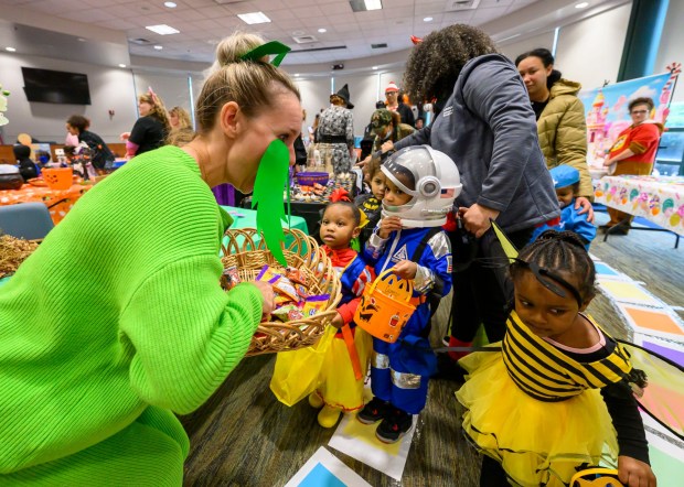 Children from Love You More Early Learning Center enjoy receiving treats from Melissa Dorflinger, Lehigh County Recruiting and Retention Manager on Friday, Oct. 31, 2025, during a Trick-or-Treat Candy Land themed adventure hosted by Lehigh County at Government Center in Allentown. (April Gamiz/The Morning Call)
