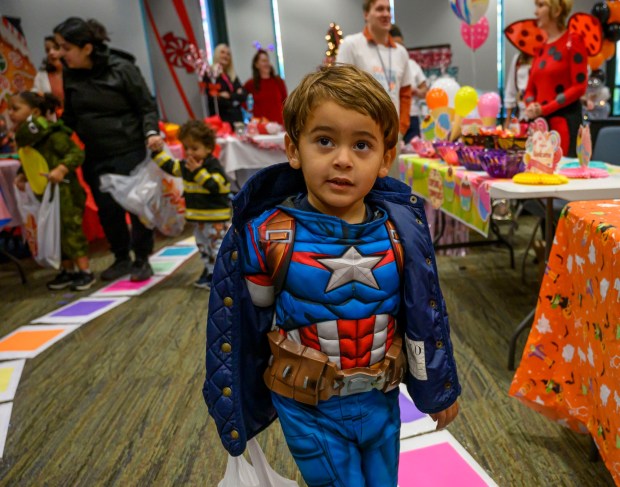 Josiah, 4, of Dream Garden Daycare And Learning Center gets treats on Friday, Oct. 31, 2025, during a Trick-or-Treat Candy Land themed adventure hosted by Lehigh County at Government Center in Allentown. (April Gamiz/The Morning Call)