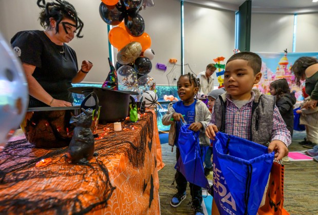 Edwin, 4, of  Resurrected Life Children's Academy receives treats on Friday, Oct. 31, 2025, during a Trick-or-Treat Candy Land themed adventure hosted by Lehigh County at Government Center in Allentown. (April Gamiz/The Morning Call)