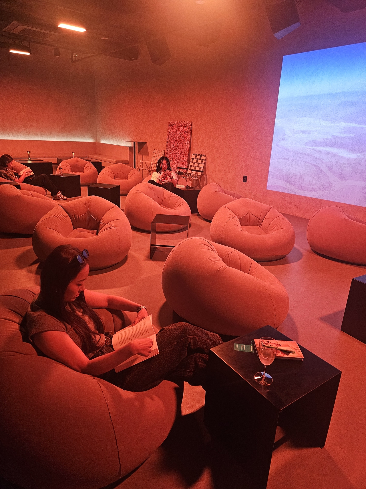 Park reads while drinking a glass of wine served as a welcome drink at Reading City. (Choi Jae-hee / The Korea Herald)