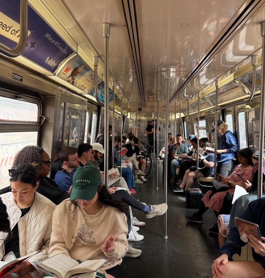 Passengers quietly read together inside a New York subway car. (Instagram @reading_rhythms)