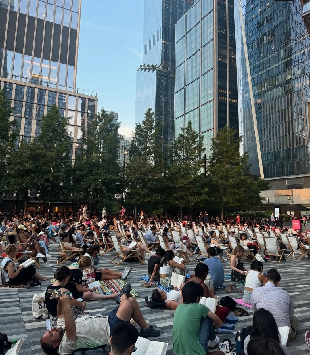 In downtown New York, dozens gather between high-rise buildings to read together.  (Instagram @reading_rhythms)