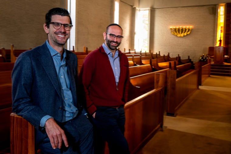 Rev. Adam Hearlson (left) of Overbrook Presbyterian Church and Rabbi Ethan Witkovsky pose at Temple Beth Hillel-Beth El in Wynnewood Tuesday, October. 28, 2025.  After a fire devastated the church building, the synagogue took the church in and what ensued was an interfaith partnership.