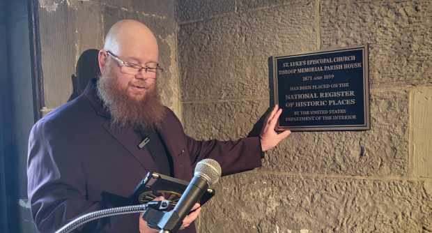 Rev. Tyler J. Parry says a prayer of dedication over...