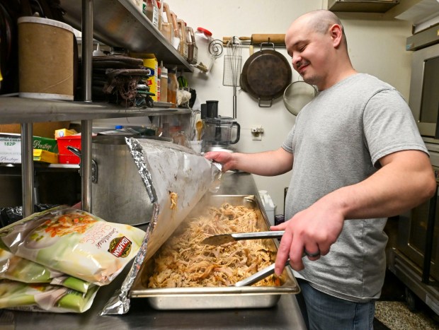 Southside Drop-in Center Coordinator Matt Fowler, stirs freshly prepared carved turkey on Thursday, Nov. 27, 2025, during New Bethany's annual free Thanksgiving meal in Bethlehem. (April Gamiz/The Morning Call)