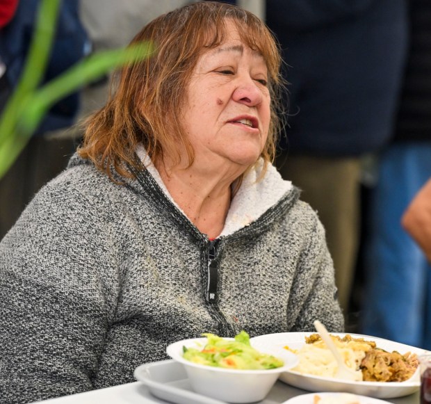 Maria Silva enjoys her meal Thursday, Nov. 27, 2025, during New Bethany's annual free Thanksgiving meal in Bethlehem. (April Gamiz/The Morning Call)