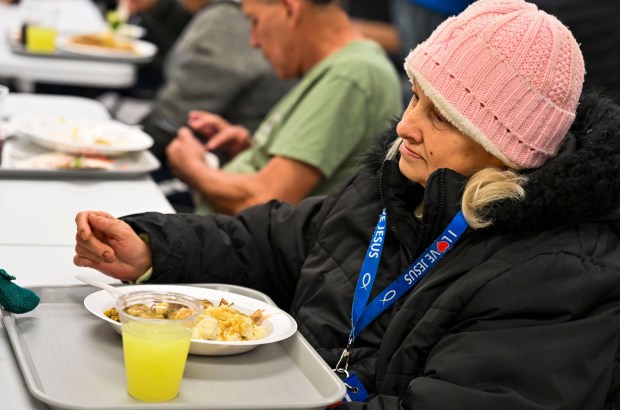 Cheryl Turtchanow enjoys her meal Thursday, Nov. 27, 2025, during New Bethany's annual free Thanksgiving meal in Bethlehem. (April Gamiz/The Morning Call)