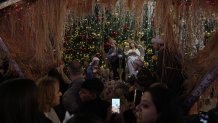 Palestinians take part in a Christmas tree–lighting event in Manger Square, next to the Church of the Nativity, traditionally regarded as the birthplace of Jesus Christ ahead of Christmas in the West Bank city of Bethlehem Saturday, Dec. 6, 2025. 
