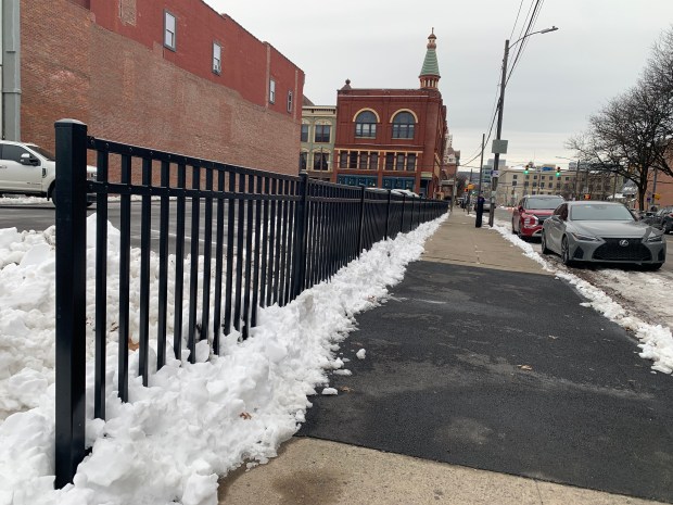 A parking lot and fence owned by Don Mammano at 301-303 Penn Ave. in Scranton on Friday, Dec. 5, 2025. (JIM LOCKWOOD / STAFF PHOTO)