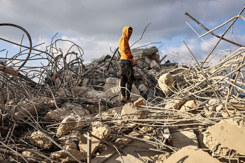 A man stands on the rubble of a house that was demolished by the Israeli army in the village of Qalandia in the West Bank on December 16.