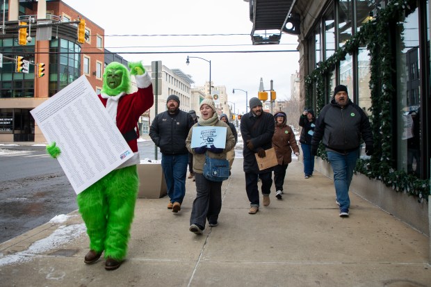 Protesters walk to U.S. Rep. Rob Bresnahan's office to deliver a petition asking the representative to restore funding to SNAP and Medicaid in downtown Scranton on Monday, Dec. 15, 2025. (REBECCA PARTICKA/STAFF PHOTOGRAPHER)