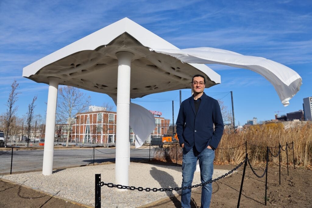 Masoud Akbarzadeh, director of the Polyhedral Structures Laboratory at the University of Pennsylvania, stands beside a structure made of 3D-printed concrete