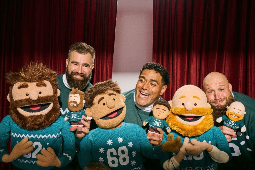 The Philly Specials (from left) Jason Kelce, Jordan Mailata, and Lane Johnson have partnered with local retailers to restock shelves with The Holiday Huddle collectible plushies.