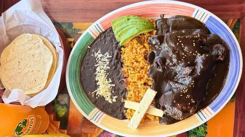 beans rice and meat with a mole sauce