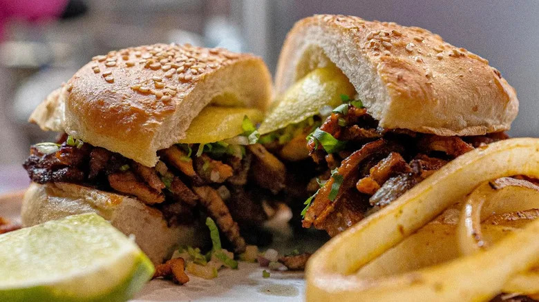 One of El Chingon's famous pork al pastor cemitas cut in half.