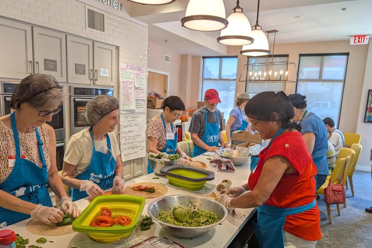 Members of the Lower Merion Village volunteer at the Jewish Family and Children's Services food pantry in Bala Cynwyd in November. The Lower Merion Village offers social activities and volunteer opportunities for older adults and people with disabilities in the Main Line community.