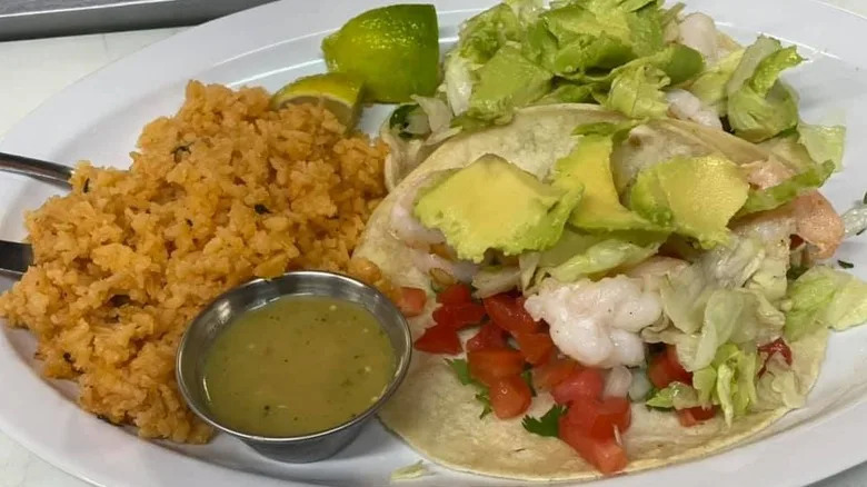 a soft taco with sides of rice and salad