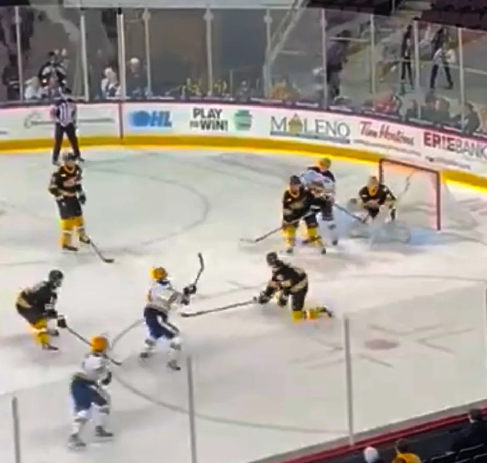 Erie Otters forward Gabriel Frasca (white jersey top), on this shot from the top of North Bay's left circle, scored through a maze of players and Battalion goaltender Mike McIvor with 1 minute, 20 seconds left in regulation of the teams' Dec. 13 Ontario Hockey League game at Erie Insurance Arena. Frasca added a second goal within the game's final minute for the hosts' 3-1 victory.