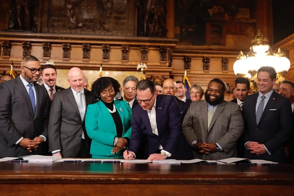 Gov. Josh Shapiro signs the fiscal year 2025-26 budget surrounded by General Assembly members on Wednesday, Nov. 12, 2025, at the Capitol in Harrisburg. The state budget had been due June 30, and Pennsylvania the final state in the country to approve a funding deal.