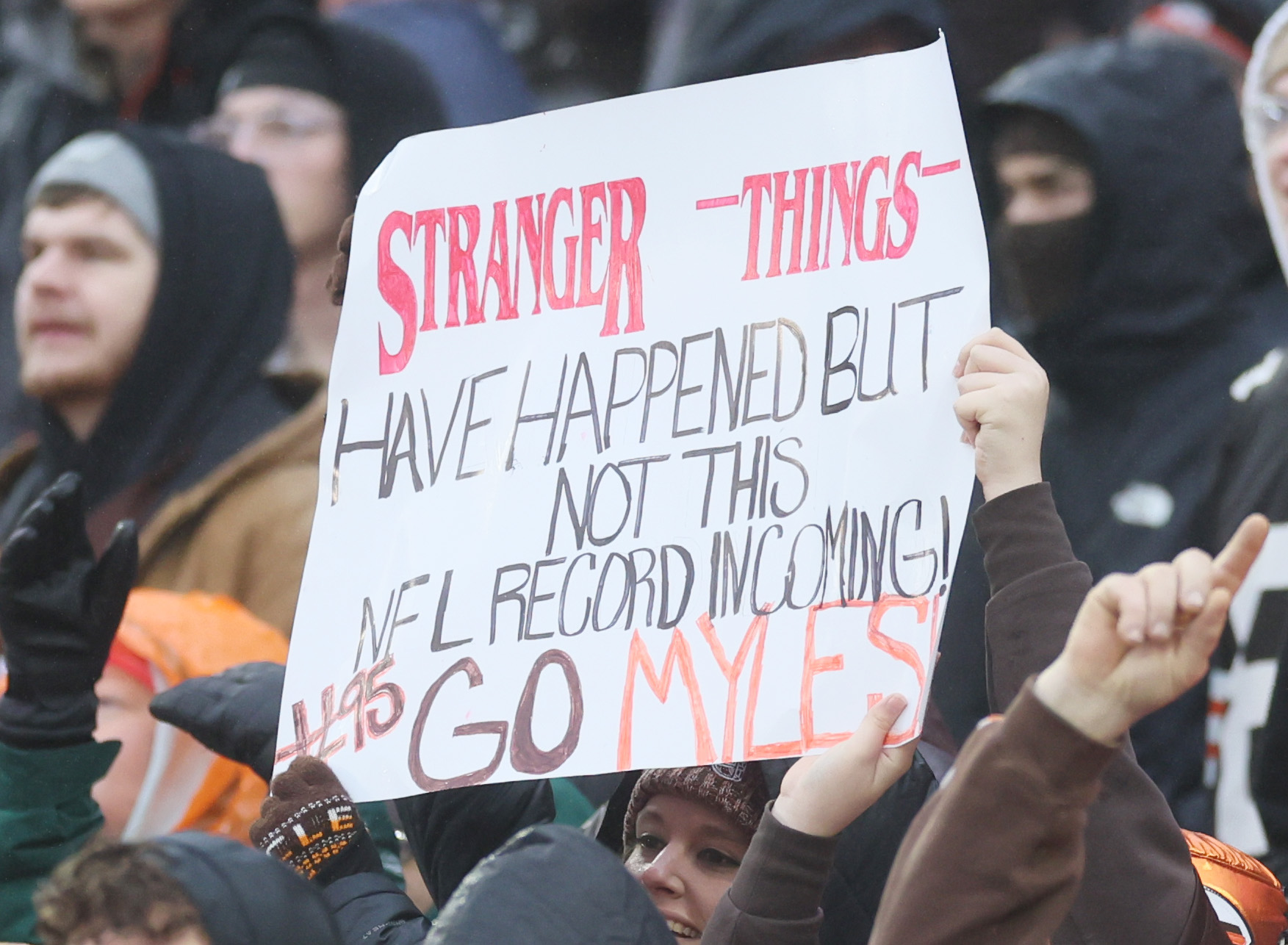 Cleveland Browns’ fans hold up signs hoping to witness Cleveland Browns defensive end Myles Garrett breaking the NFL record for sacks in a season.  