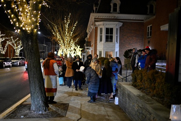 A group follows their guide through "A Night in Bethlehem" at Westminster United Methodist Church. (Thomas Walker/Freelance)