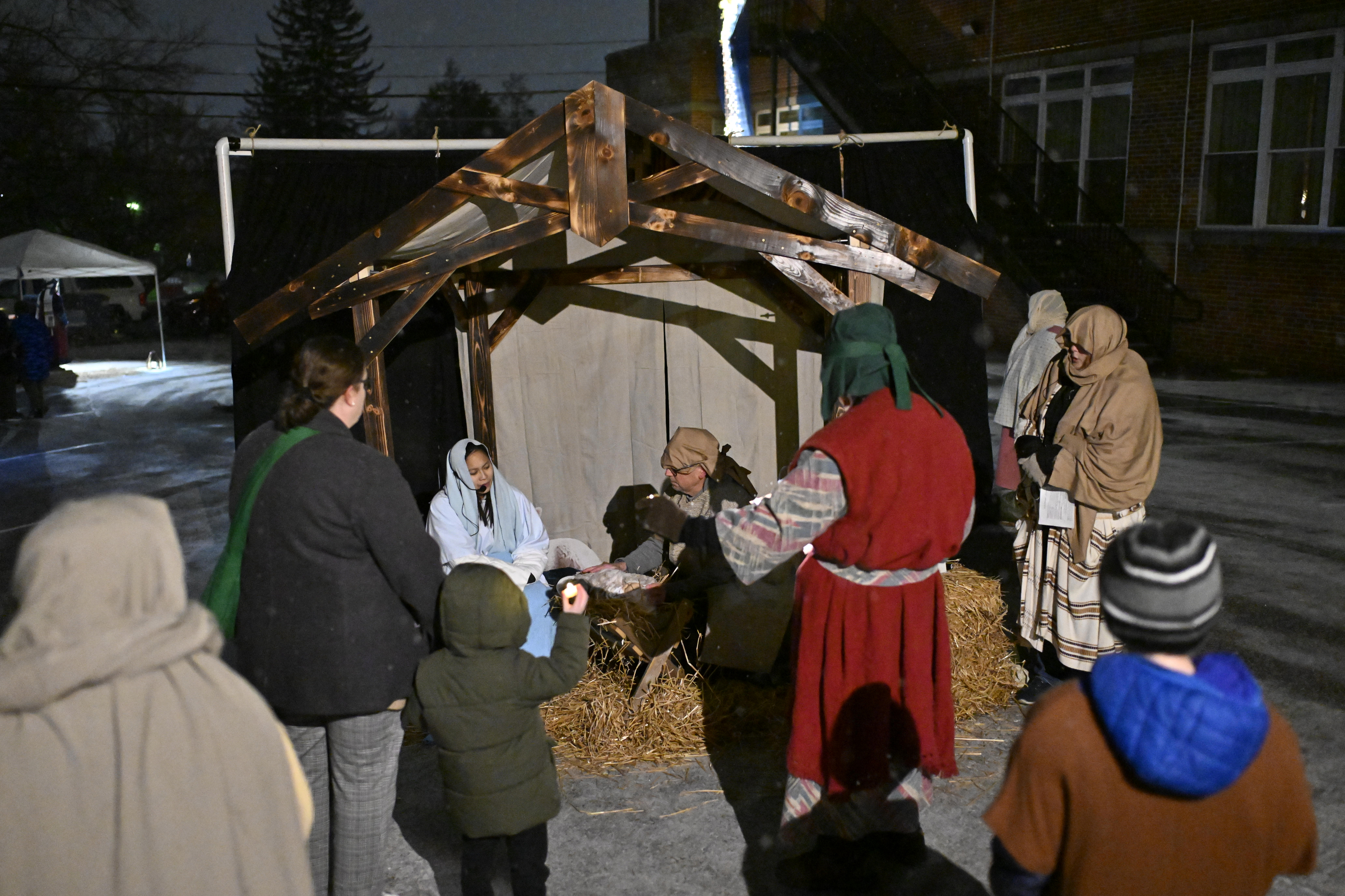 Travelers gather around Mary, Joseph, and the baby Jesus during "A Night in Bethlehem" at Westminster United Methodist Church. (Thomas Walker/Freelance)