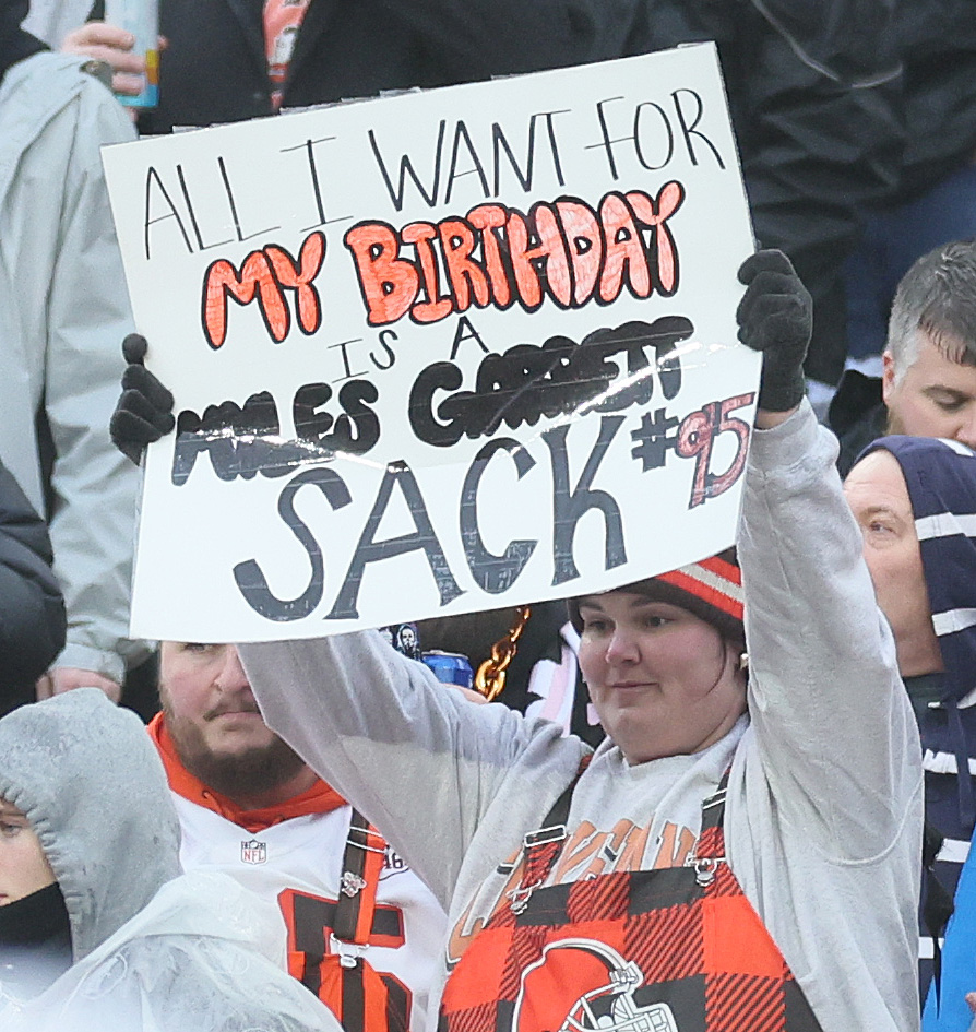 Cleveland Browns’ fans hold up signs hoping to witness Cleveland Browns defensive end Myles Garrett breaking the NFL record for sacks in a season.  